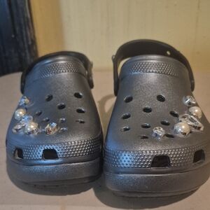 Navy Crocs With Pearl Embellishments.